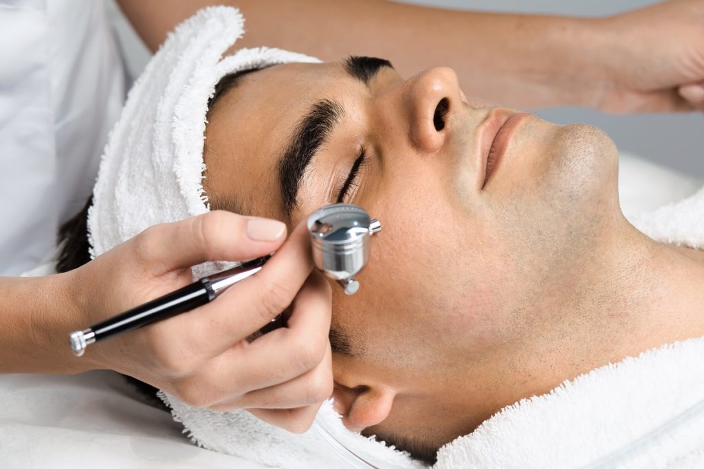 Facial beauty treatment of good looking man with oxygen epidermal peeling | Revive MD Inc in Barrie, ON