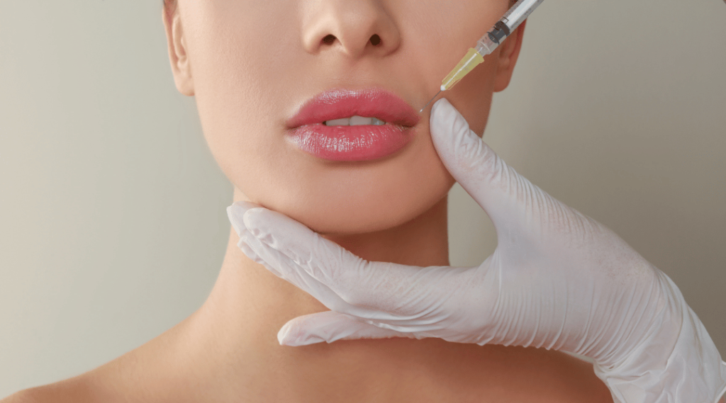 A young woman, excited for her first lip filler experience, enters a serene med spa. She’s greeted warmly and feels instantly at ease. In the consultation, her provider listens carefully, discussing her goals for natural-looking, fuller lips. A customized treatment plan is created, ensuring subtle enhancement and preserving her unique features. During the session, she feels comfortable, supported by the expertise and care of her practitioner. She leaves feeling confident, admiring the immediate yet soft results—a fuller, balanced smile that fits her face perfectly. Her journey with lip fillers becomes a cherished memory, symbolizing her renewed confidence and beauty